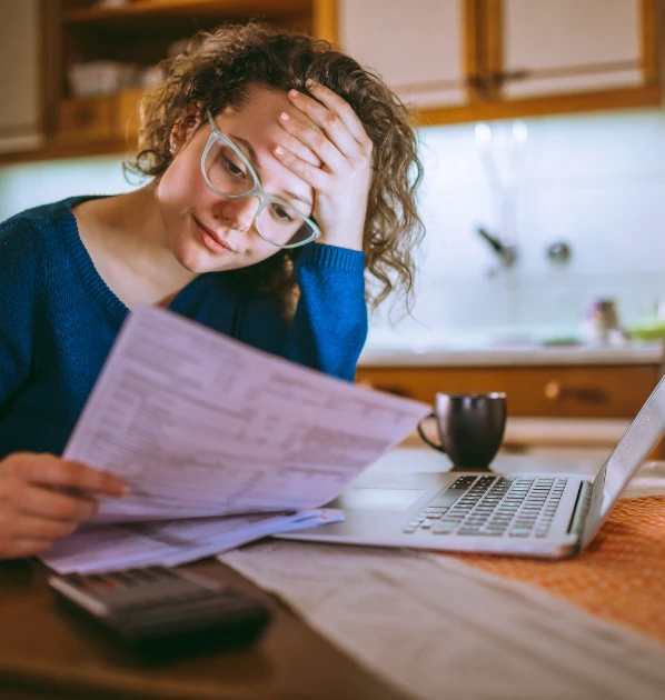 Concerned woman looking at bills